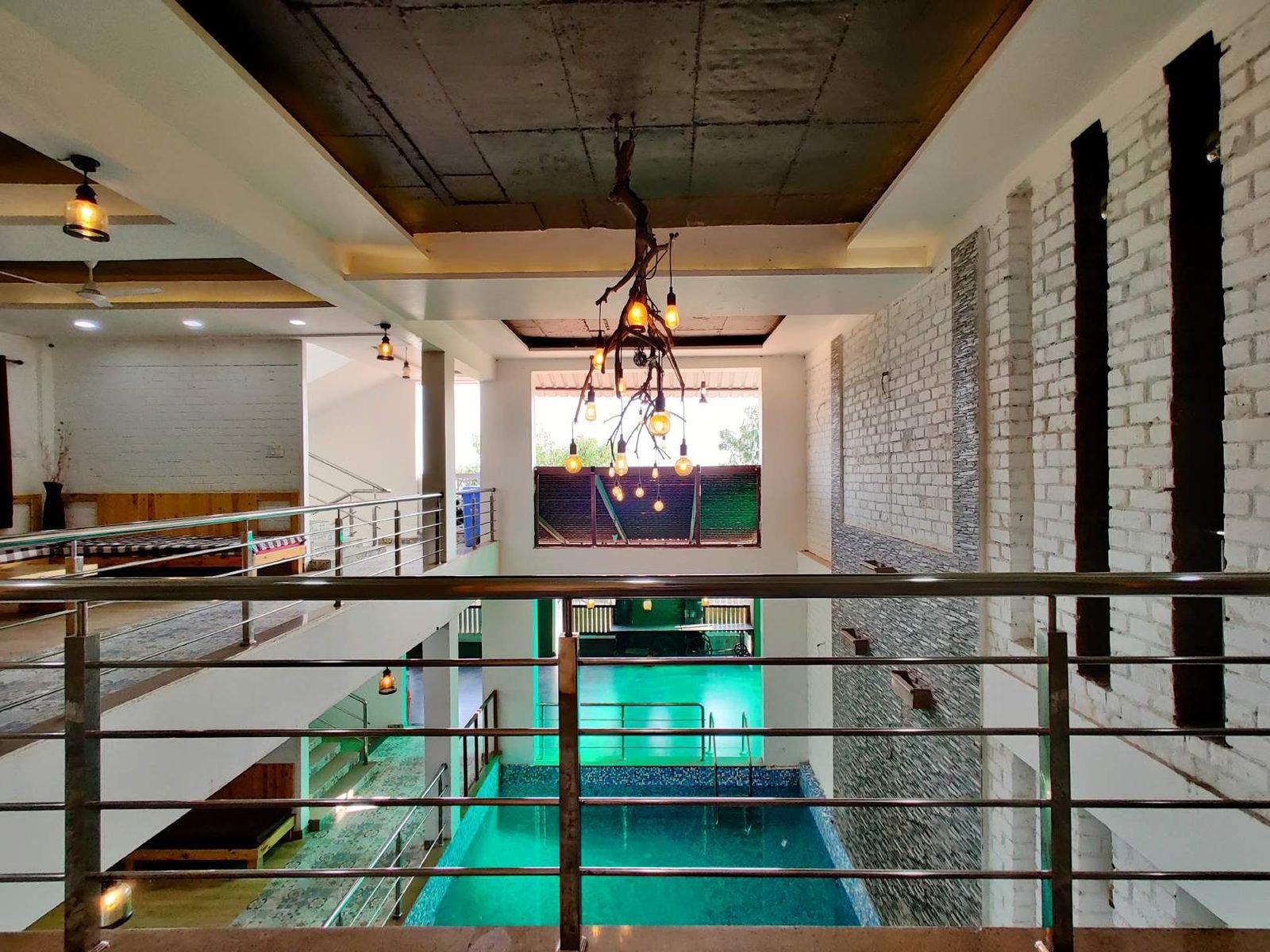 Double-height atrium above the pool at Mangli Lake Farm