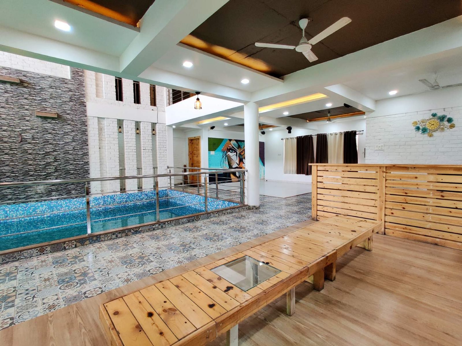 Wooden pool deck lounge at Mangli Lake Farm