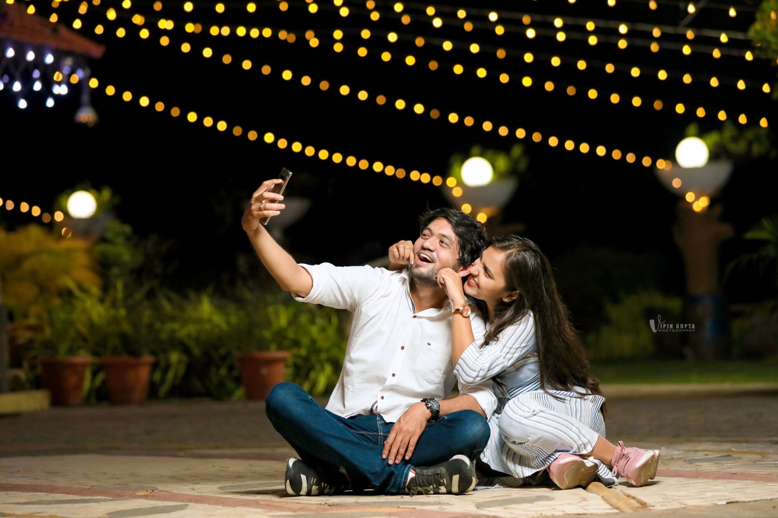 Pre-wedding selfie under string lights at Mangli Lake Farm