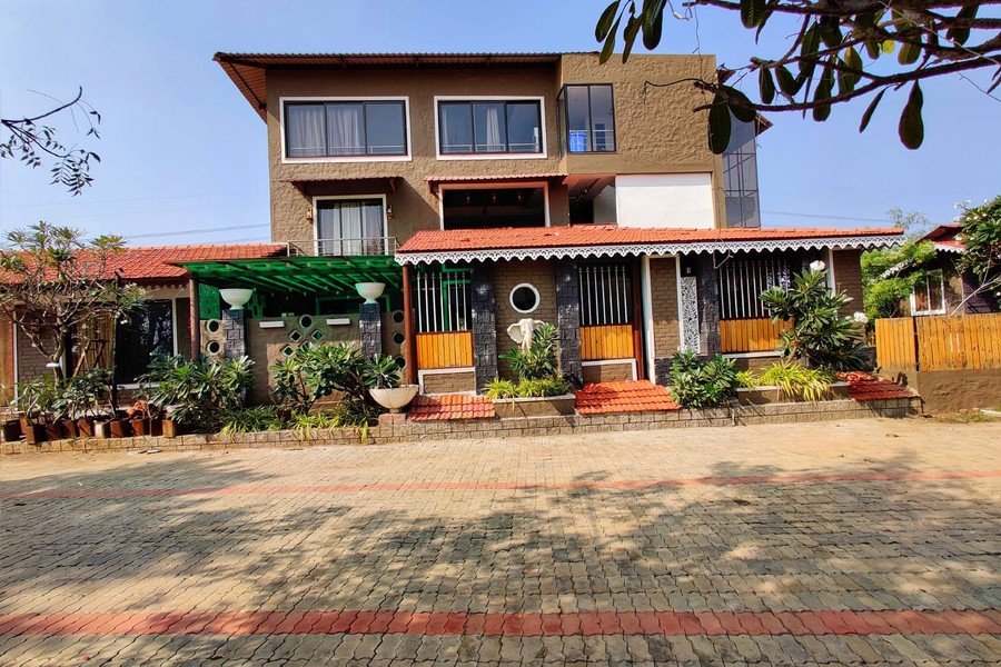 Palm Leaf Villa exterior at Mangli Lake Farm